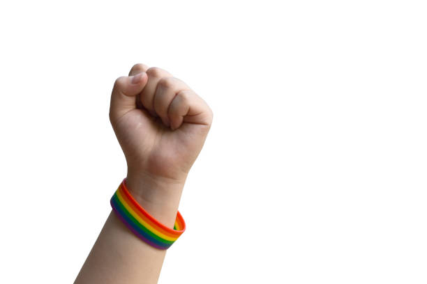 Isolated human left fist with rainbow wristband, clipping paths.
