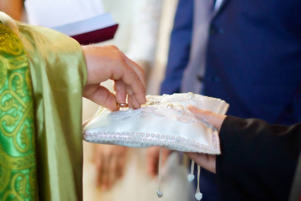 istock A Christian priest holds in his hands a wedding ring. 1800594114