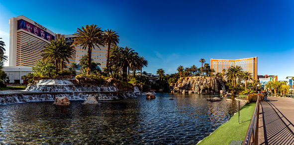 Las Vegas; USA; January 18, 2023: Panoramic view of the volcano lake of The Mirage casino and resort, in the middle of the Boulevard of the famous Las Vegas Strip on a sunny day and blue sky.