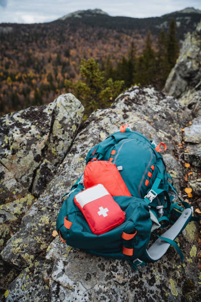 istock A mountain hike with a backpack, a tourist's equipment on a hike, a first aid kit on the backpack, a box with medicines. 1800612643