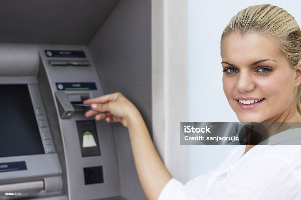 Beautiful businesswoman withdrawing money from credit card at ATM 25-29 Years Stock Photo