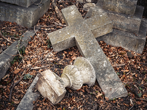 Calgary, Alberta, Canada â October 9, 2022: Tombstones in a Chinese graveyard on the hill in Calgary with a blue sky in the background