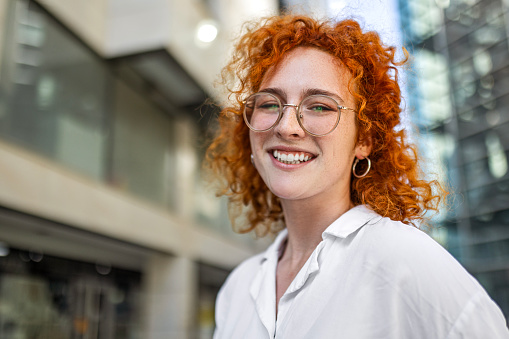 Smiling young redhead businesswoman