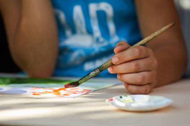 istock The child's hand draws a drawing with gouache paints. 1800719255