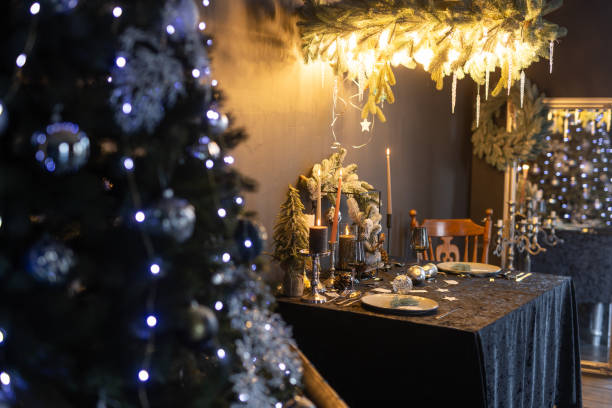 istock New Year's dark interior, Christmas tree with New Year's decorations and a decorated table in a dark style 1800738366