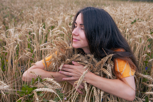 Beautiful young woman in a wheat field, Ukraine