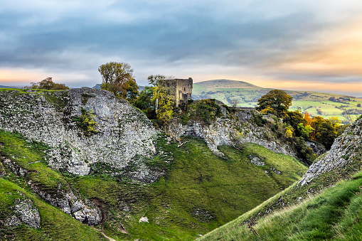 Sunrise at Cave Dale near Castleton in the Peak District National Park, overlooked by the ruins of Peveril castle.