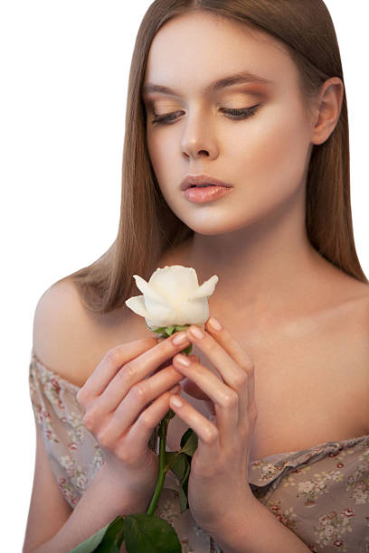 istock Woman with white rose in her hands looking down 180077965