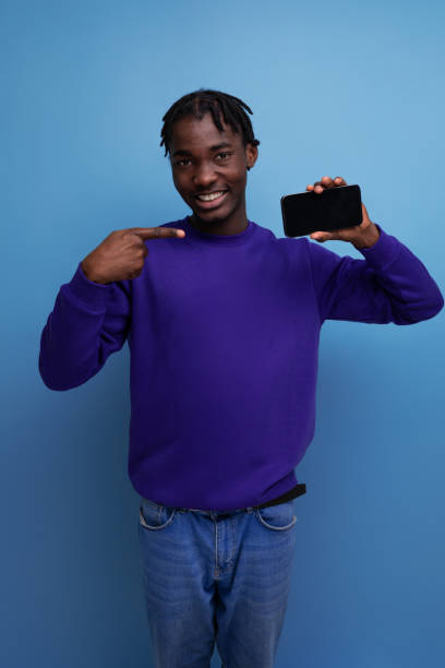 istock lucky winner african young man with dreadlocks with phone on studio background 1800792629