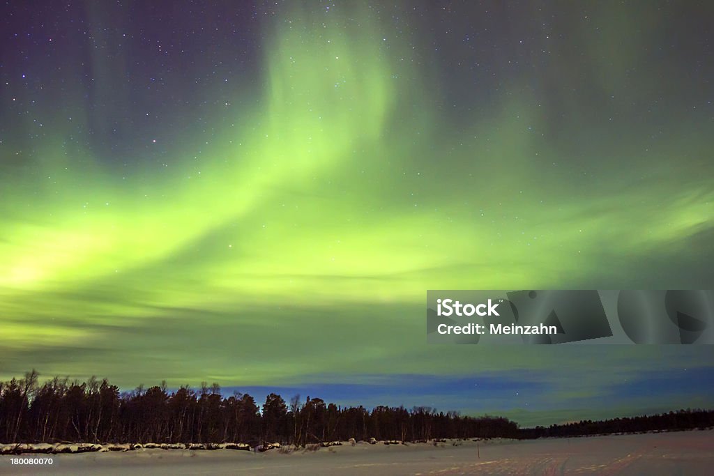 Northern Lights (Aurora borealis) over snowscape. Adventure Stock Photo