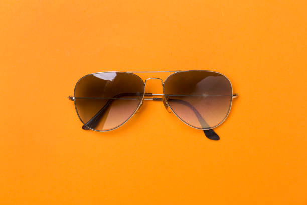 istock Sunglasses on color background, top view. 1800801616
