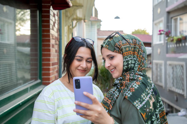 istock Two girlfriends taking selfie on the street 1800802779
