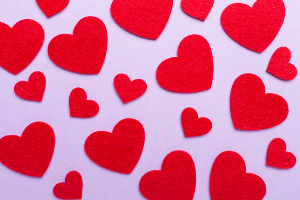 Felt hearts on color background, top view Felt hearts on color background, top view felt heart shape small red stock pictures, royalty-free photos & images