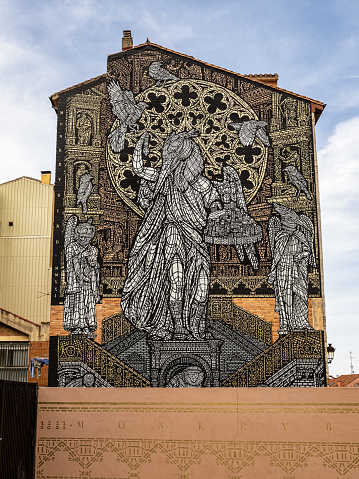 Burgos, Spain - Jun 17, 2023: Mural called Monkey Bird in Burgos, Castille and Leon, Spain. MonkeyBird paint monumental stencil tribute to Burgos Cathedral