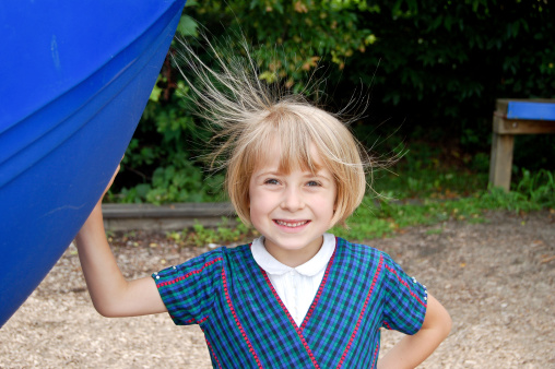 The power of static electricity is captured in this young girl's flying hair.