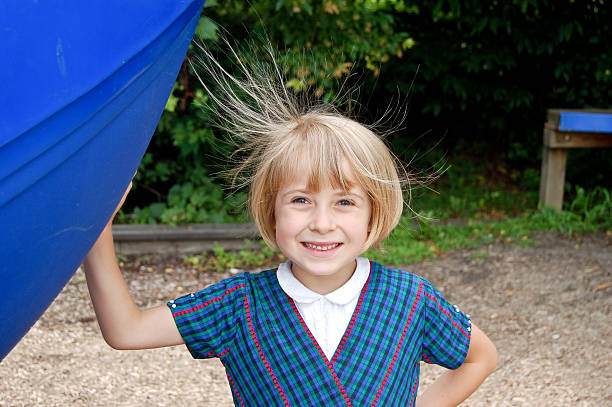 Smiling girl with static hair stock photo