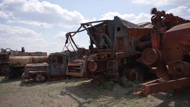 Rural rusty machinery is abandoned in the open air in a field