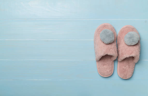 istock Soft pink slippers on wooden background, top view 1800872463