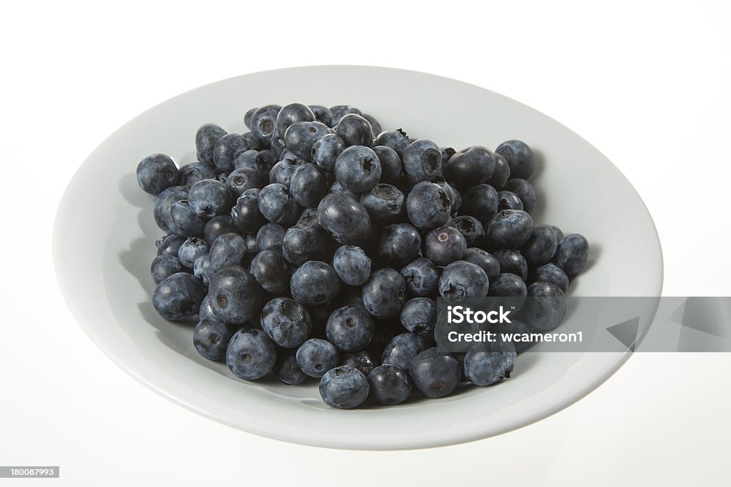 Blueberries in bowl on white background Fresh blueberries in a white bowl on a white background. Berry Fruit Stock Photo