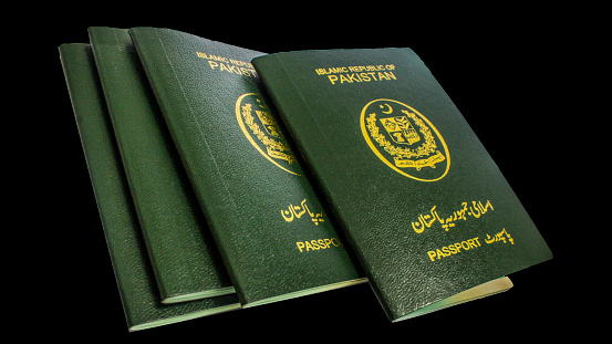 Karachi, Pakistan - 19 November 2023: Four Pakistani Passports with Black Background.