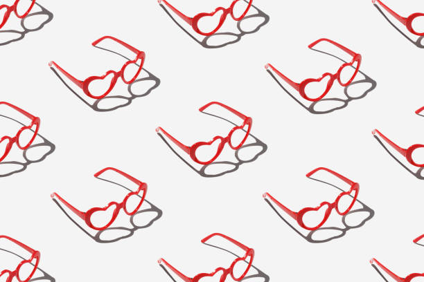 istock Pattern made with red heart shaped sunglasses on pastel color background 1800934914