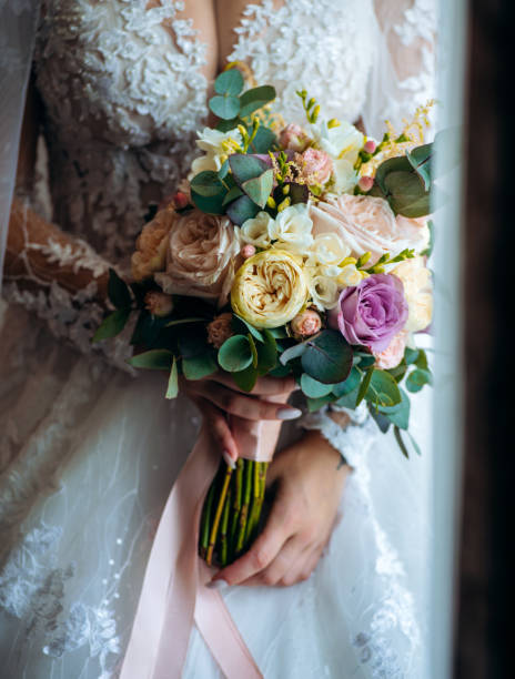 istock wedding bouquet in bride's hands, close up 1800953444
