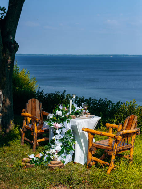 istock Dining table and chairs prepared for romantic dinner against the sea view 1800953447