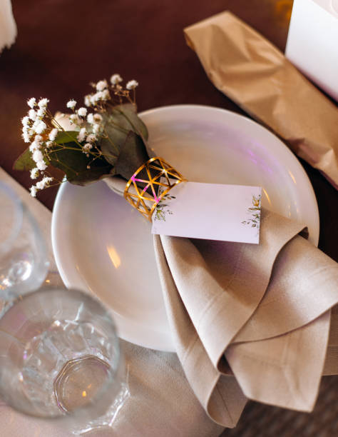 istock Wedding table setting with blank guest card, napkin, succulent and dish on a white plate. 1800953451