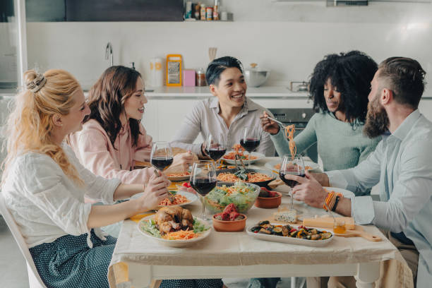 istock Group of multiethnic friends sitting at the table during lunch 1800953457