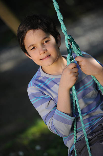 istock Child playing with swing in a park 180096368