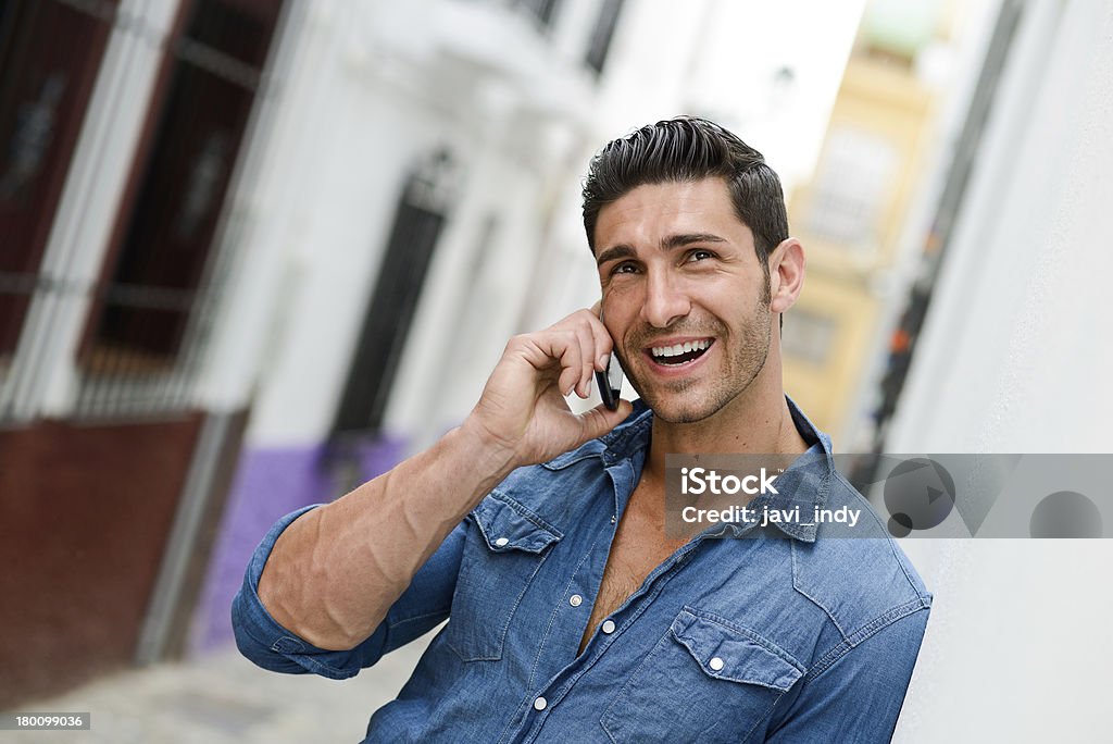 Attractive young man talking on the mobile phone Portrait of an attractive young man talking on the mobile phone Adult Stock Photo