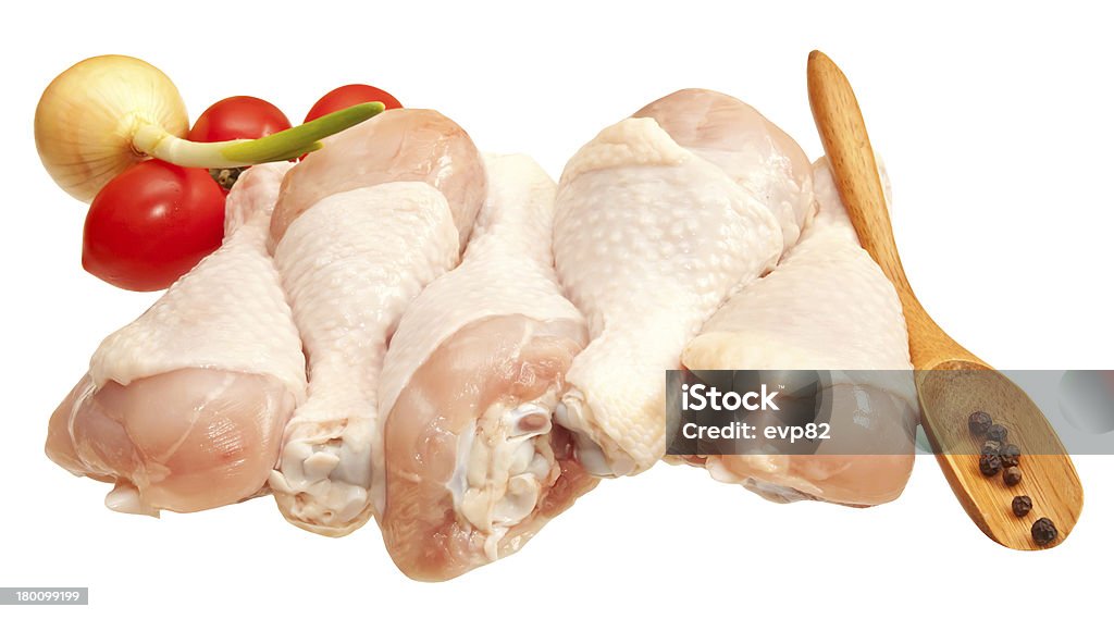 Raw chicken legs with vegetables, isolated on white background Raw chicken legs with vegetables, isolated on white background. Animal Body Part Stock Photo