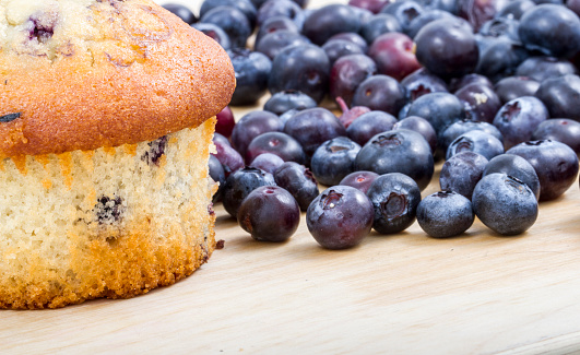 baked blueberry muffin and blueberries