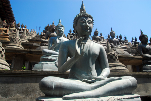 Colombo, Sri Lanka: Gangaramaya Temple - one of a thousand Buddhas, Vitarka Mudra, the circle formed by the thumb and index finger represents the Wheel of Law - Slave island, Beira Lake - photo by M.Torres