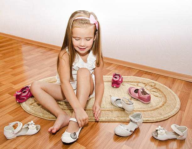 istock Cute little girl  puts her shoes 180102829