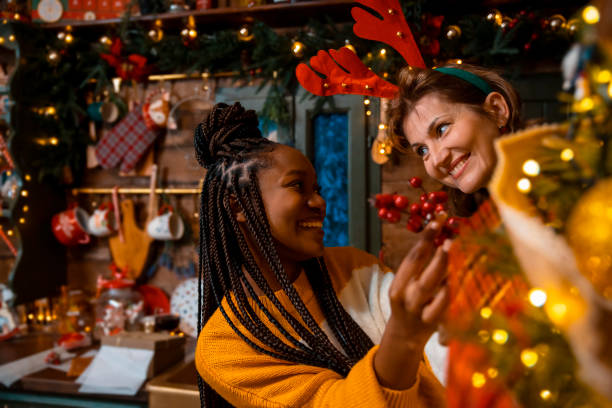 istock Multiracial female family decorating Christmas tree 1801030379