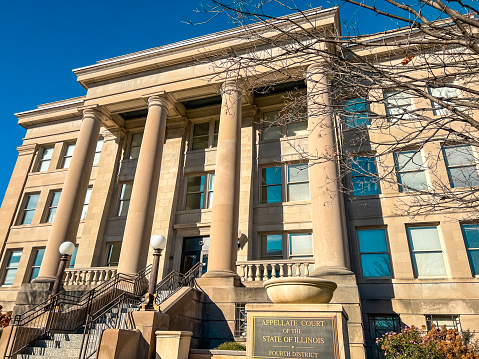 Looking up at the exterior of the Appellate Court of the State of Illinois District Building in Springfield, Illinois, USA. Vivid clear blue skies overhead.