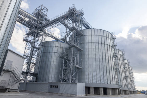 istock Modern industrial grain Elevator for grain storage. Steel silos for storing grain on a agricultural farm. 1801044072