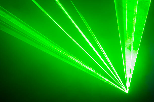 Green Laser Light Beams of green laser light illuminate a cloud of smoke. dubstep photos stock pictures, royalty-free photos & images