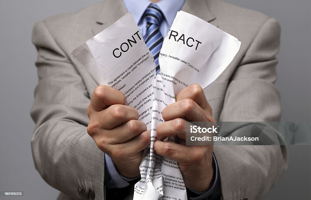 Man in business wear tearing up a contract with his hands Angry businessman tearing up a document, contract or agreement Contract Stock Photo