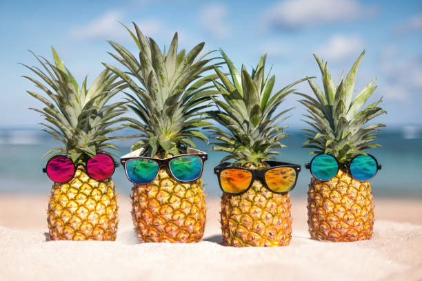 istock Two pineapples with trendy sunglasses in tropical paradise 1801076836