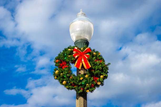 istock Christmas wreath hanging on lamp post 1801086352