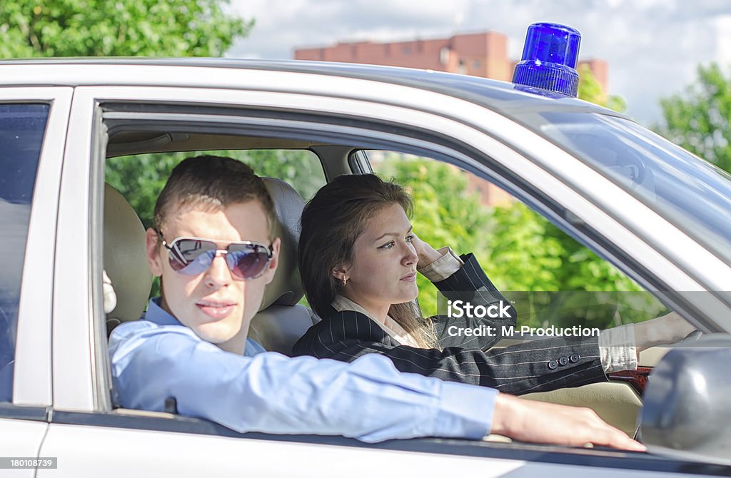 Two young detectives driving to crime scene. Adult Stock Photo