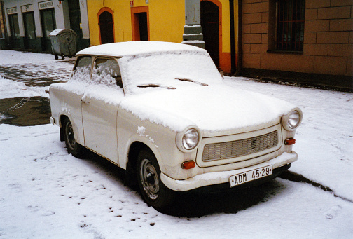 Prague, Czech Republic: Trabant 601 covered in snow - car model produced from 1957 until 1991 by former East German car manufacturer VEB Sachsenring Automobilwerke Zwickau. It features a duroplast body on a steel chassis, front-wheel drive, a transverse two-stroke engine, and independent suspension. The Trabant became symbolic of the former East Germany's stagnant economy and the collapse of the Eastern Bloc in general. Trabbi in winter.