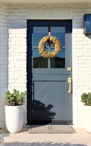 istock Old fashioned brick cottage with modern teal Dutch door 1801127704