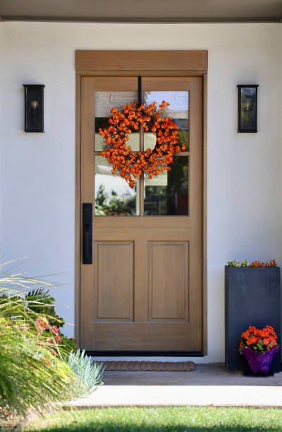 istock Natural wood front door with autumn wreath 1801130163