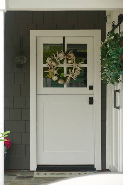 istock White Dutch door with seashell wreath 1801132790