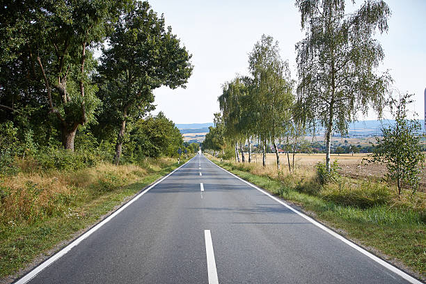istock country road on a beautiful sunny day 180115349