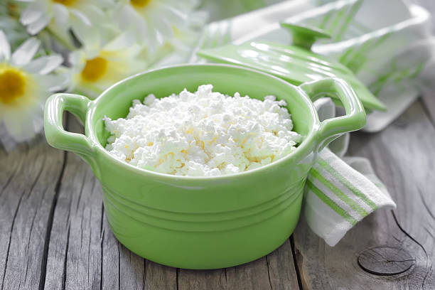 Cottage cheese in a green dish Cottage cheese cottage cheese photos stock pictures, royalty-free photos & images