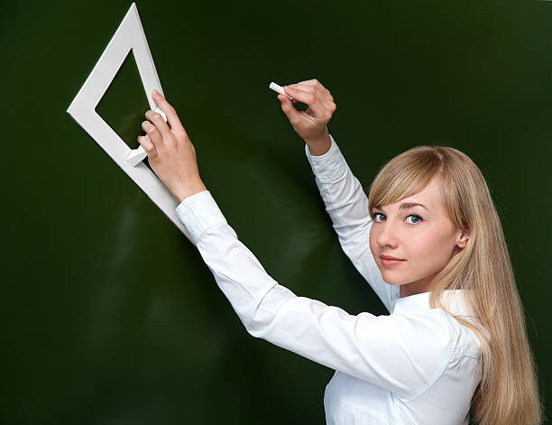 istock girl drawing on a blackboard in the class 180116310